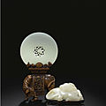 A white jade pierced disc with boxwood 'elephant' stand, qing dynasty, 18th century
