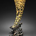 A carved rhinoceros horn with landscape and figural decoration, 19th century