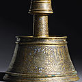 An important mamluk silver-inlaid brass candlestick, egypt, late 13th-first half 14th century
