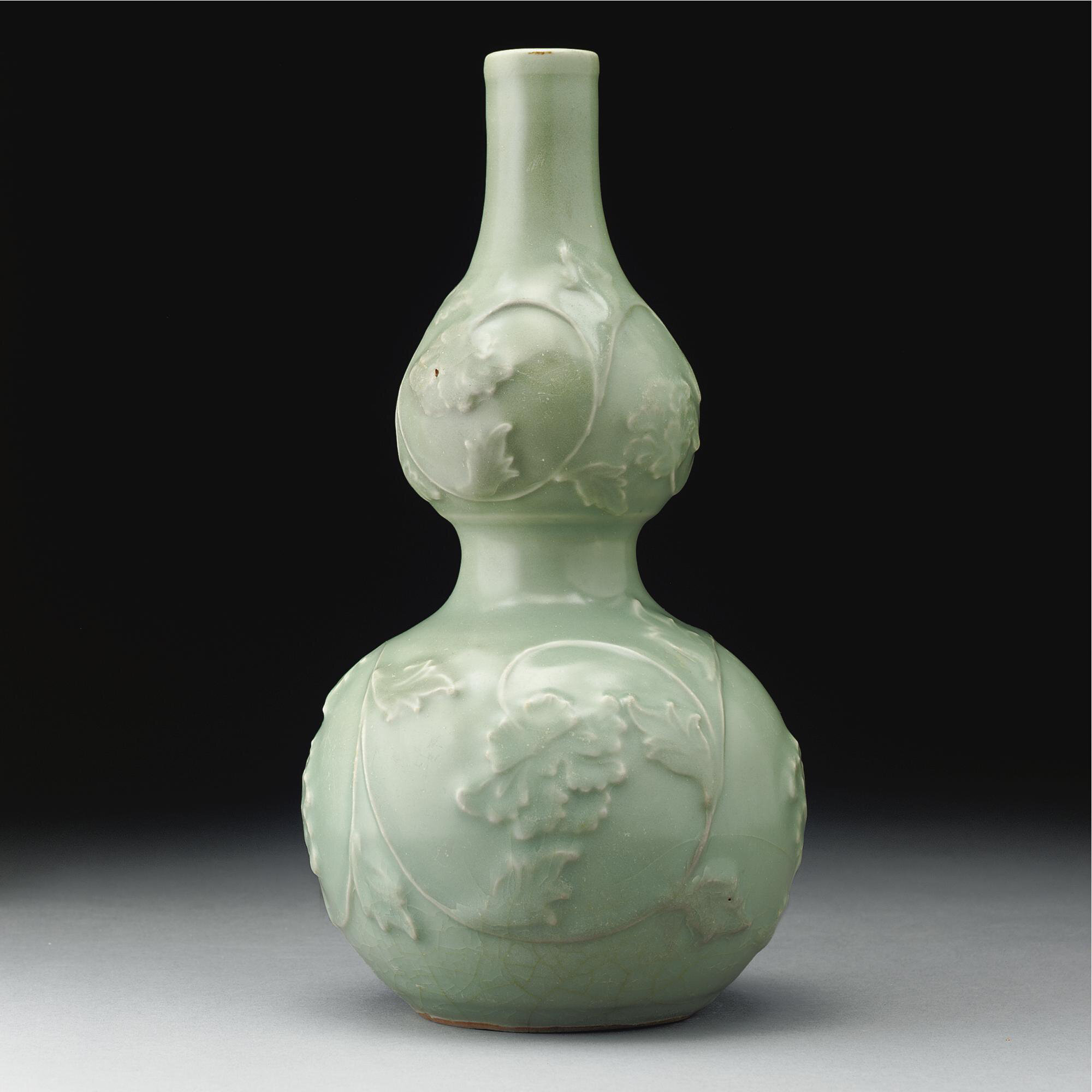 A rare 'Longquan' celadon double-gourd vase with applied decoration, Yuan dynasty (1279-1368)