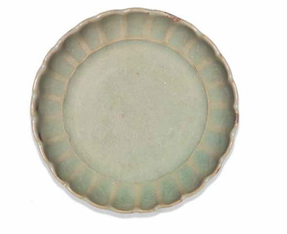 A rare small Junyao green-glazed 'chrysanthemum' dish, 13th-14th century