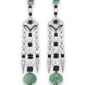 A pair of elegant art deco emerald, diamond and onyx ear pendants, by cartier