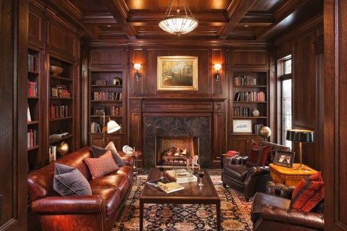 New-Traditional-Living-Designs-with-ark-paneled-library-complete-with-beautiful-books-comfortable-leather-furniture-and-brass-accents