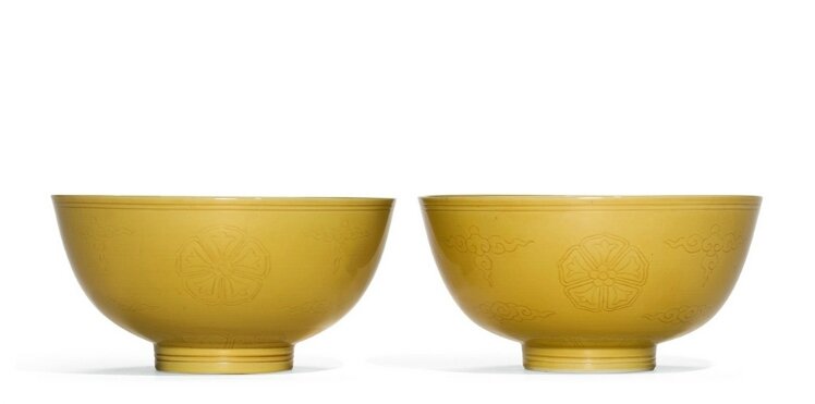 A pair of incised yellow-glazed bowls, Qianlong seal marks and period