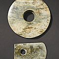 A large calcified jade axe blade, yue, and a jade disc, bi ; the disc: possibly neolithic period, the blade later
