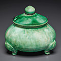 A small green-glazed tripod jar and cover, Tang dynasty (AD 618-907)