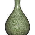 A finely carved 'longquan' celadon-glazed 'peony' bottle vase, yuhuchunping, ming dynasty, hongwu period (1368-1398)