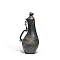 A rare archaic bronze 'gourd' vase and cover, hu. eastern zhou dynasty (770-221 bc)