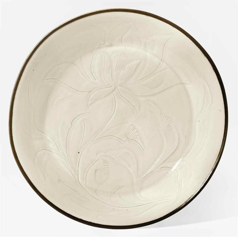 A rare and finely carved Ding 'lotus' dish, Northern Song dynasty, 11th-12th century